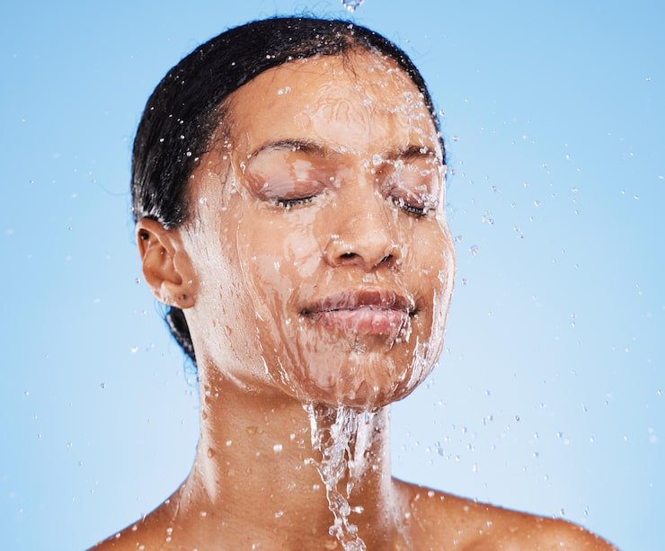 woman shower water splash face skincare hydration clean hygiene against blue studio background female facial wash with water hydrate cleanse hygienic body care treatment 590464 106089